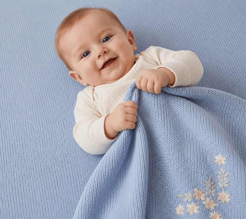 Soft light blue baby blanket with embroided flowers