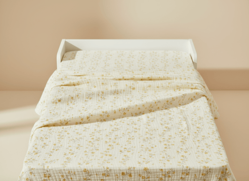 Light flower-themed yellow baby blanket