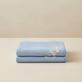 Soft light blue baby blanket with embroided flowers