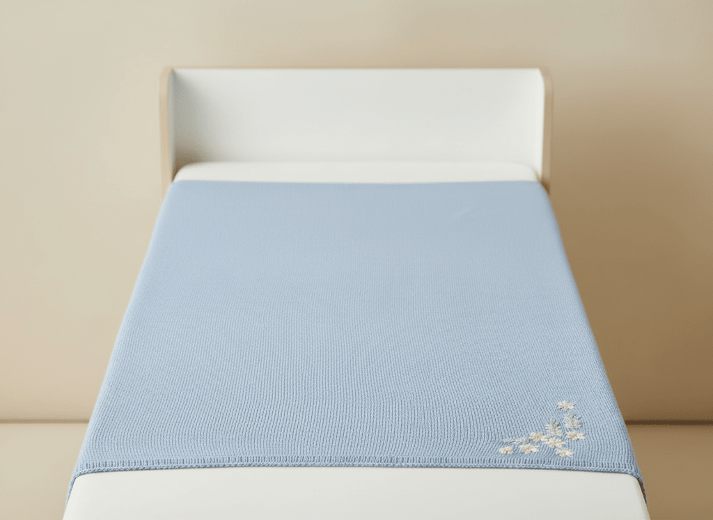 Soft light blue baby blanket with embroided flowers