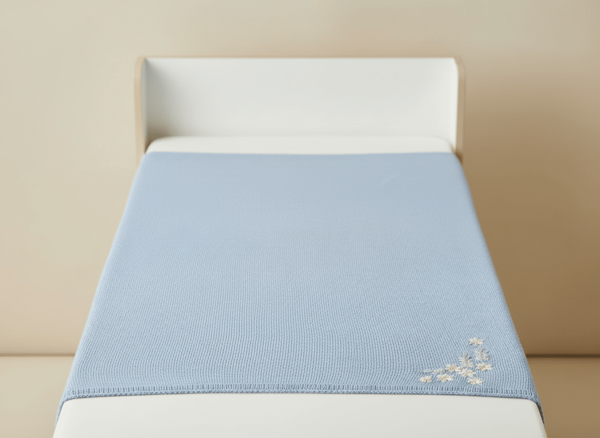 Soft light blue baby blanket with embroided flowers